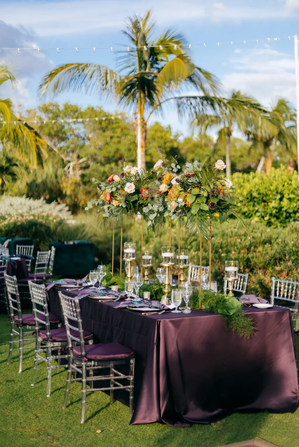 Jewel-Toned Moody Fall Wedding Reception Table Decor Ideas | Ghost Chiavari Chairs with Eggplant Dark Purple Table Linen and Tall Centerpiece Inspiration | Sarasota Event Venue The Resort at Longboat Key Club