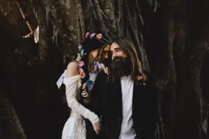 Romantic Bride and Groom Under Large Live Oak Tree Wedding Portrait | Boho Flower Hair Braid Inspiration