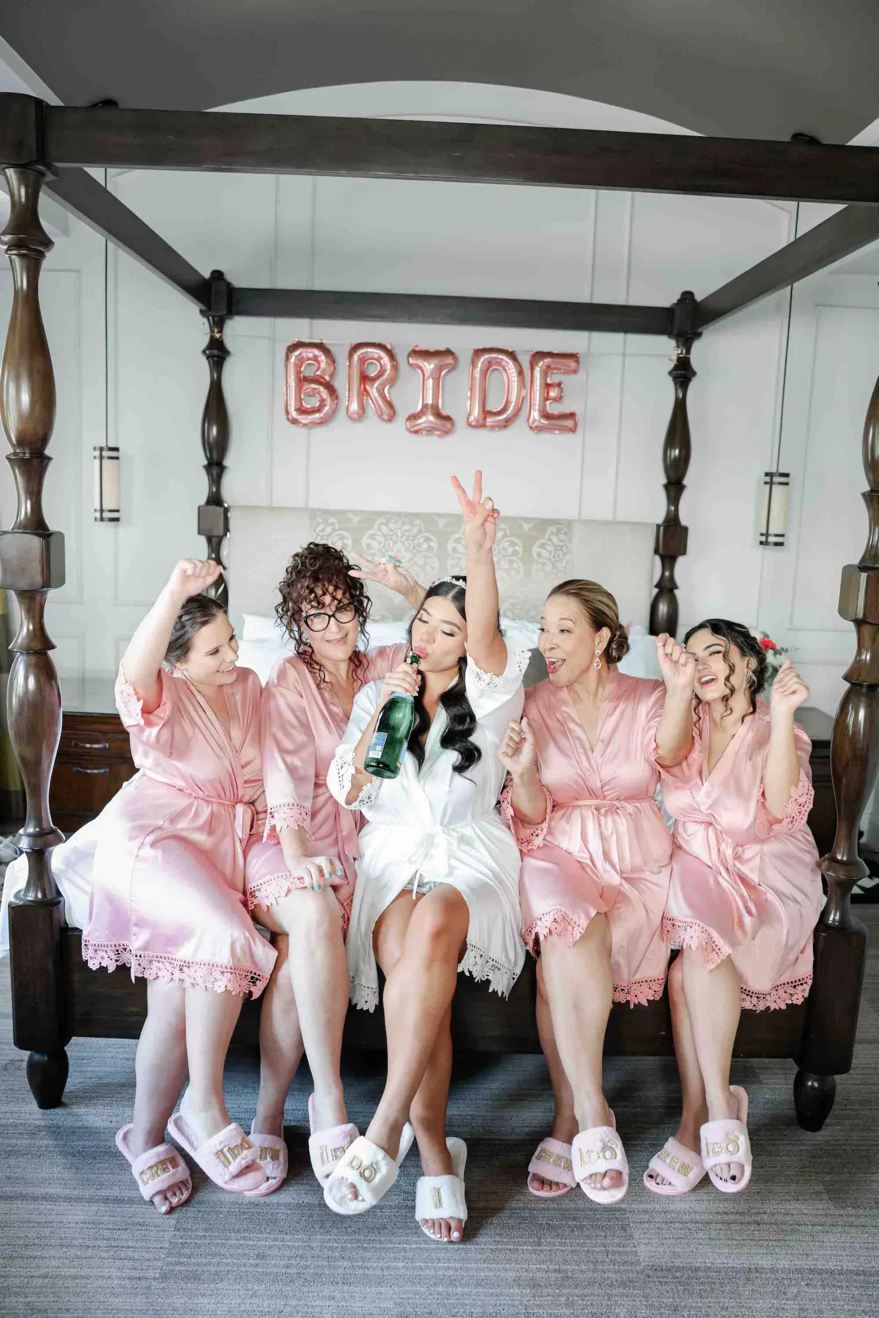 Bride Celebrating with Bridesmaids Wedding Portrait | Matching Pink Robes and Slippers Inspiration