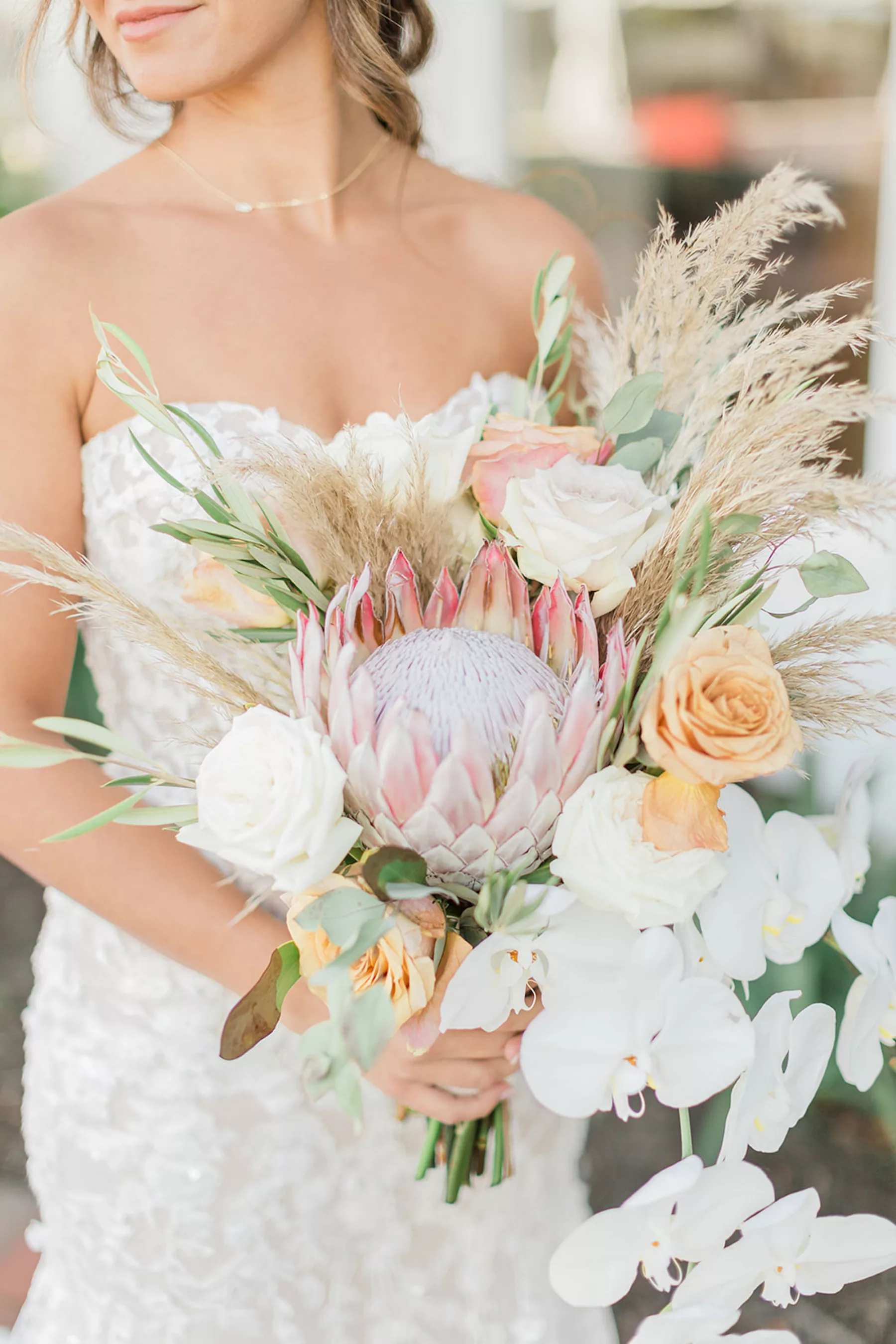 Boho Fall Wedding Bouquet Ideas with Pampas Grass, White and Orange Roses, Pink King Protea, Orchids, and Eucalyptus
