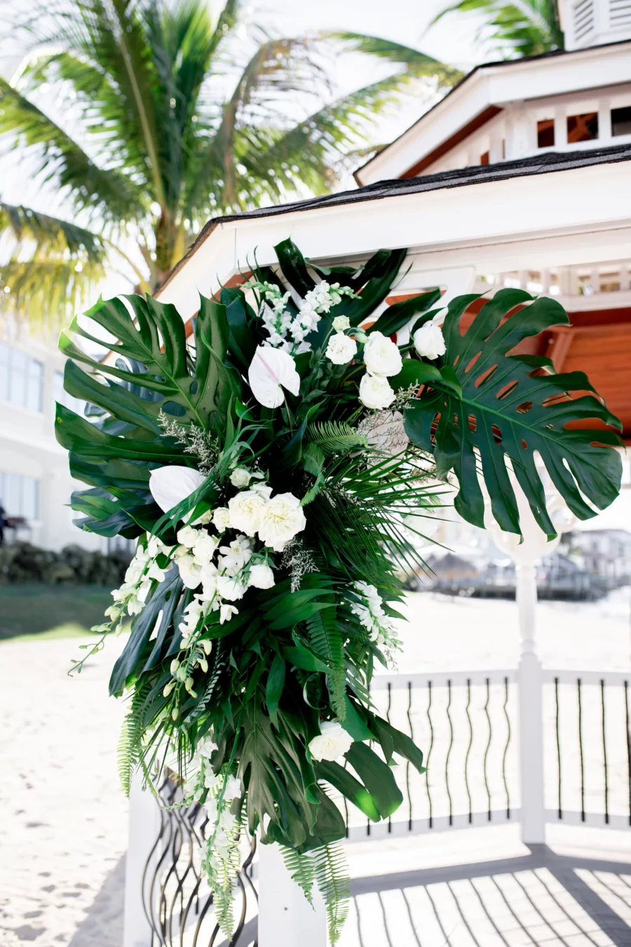 Tropical Monstera, Palm Leaf, and White Roses Wedding Ceremony Gazebo Decor Ideas