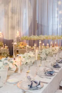 Whimsical White Wedding Reception Centerpiece Inspiration | Long Feasting Tables with Floating Candles, and Rose Table Top Flower Arrangement Ideas