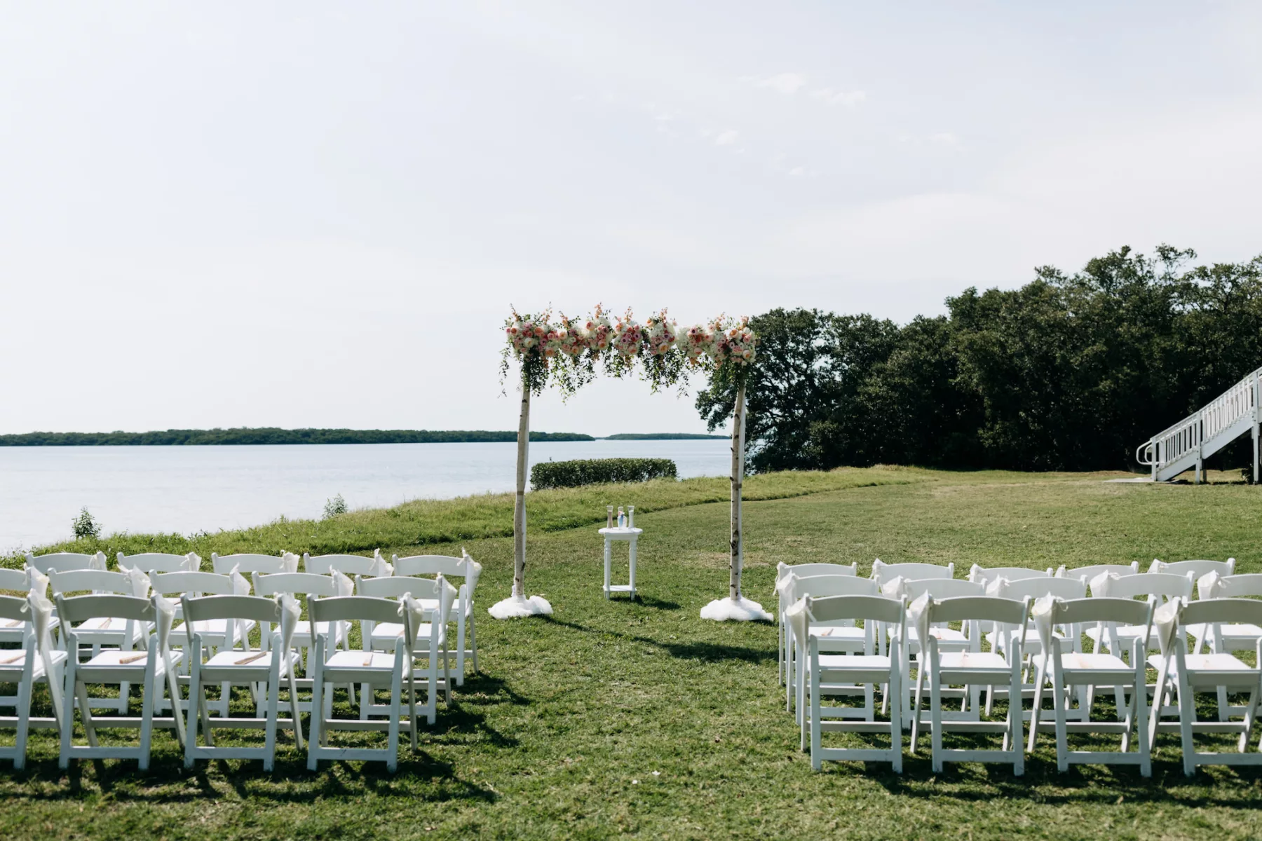 Outdoor Waterfront Wedding Ceremony with White Folding Garden Chairs Inspiration | St. Petersburg Venue Tampa Bay Watch