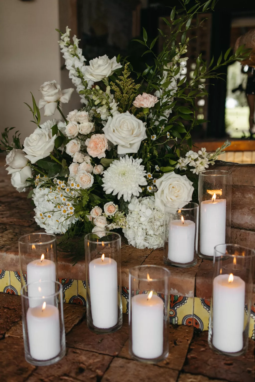 Candlelit Wedding Venue Entrance Decor Ideas | White Roses, Hydrangeas, Chrysanthemums, Feverfew Daisies, Stock Flowers, and Greenery