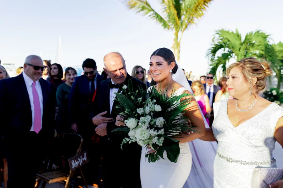 Bride with Father and Mother Walking Down Wedding Aisle | Elegant Updo Hair and Makeup Ideas | St Pete Hair and Makeup Artist Femme Akoi Beauty Studio