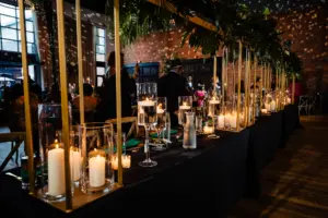 Elegant Tropical Black and Emerald Wedding Indoor Reception Decor Inspiration | Tall Gold Flower Stand with Pillar Candles