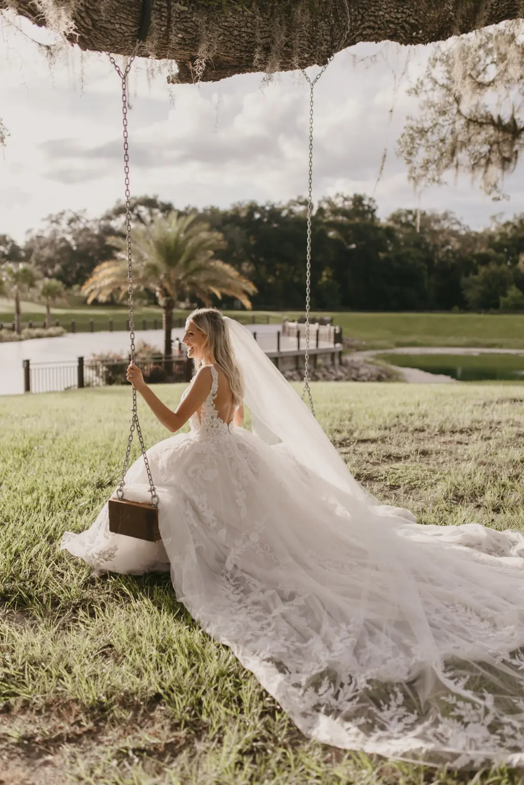 Bride Swinging in White Open Back Lace and Tulle Lillian West Wedding Dress with Maggie Sottero Veil Inspiration | Tampa Bay Photographer Valentina Rose Photography | Event Venue Simpson Lakes