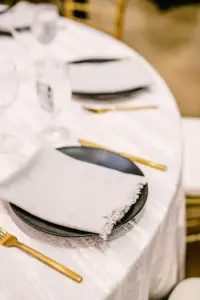 Modern Minimalist Wedding Reception Tablescape Ideas | Matte Black Plates, White Raw Edge Napkin Linen, with Gold Flatware | Tampa Bay Rental Company A Chair Affair