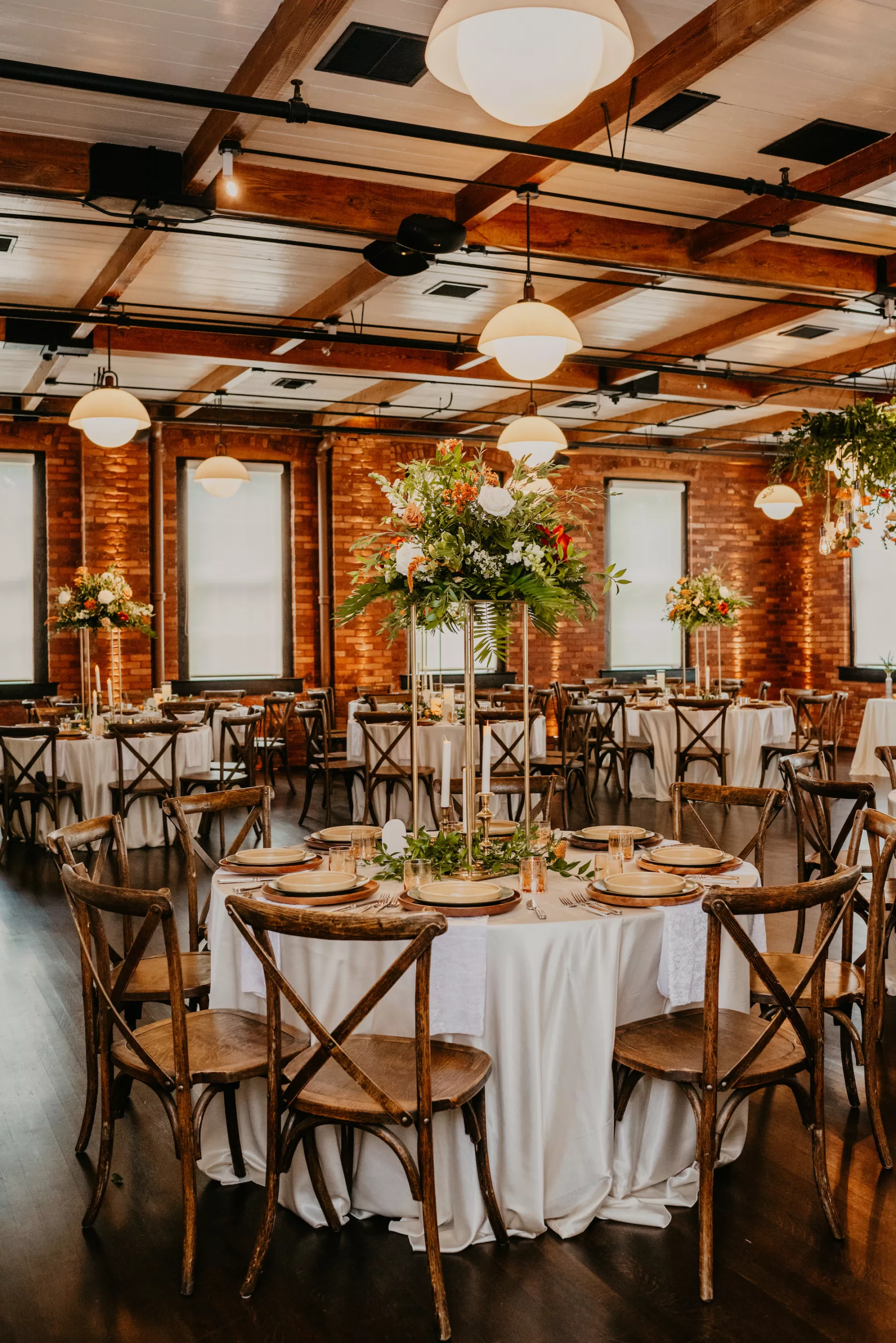 Boho Industrial Wedding Reception Inspiration | Gold Flower Stands with White Roses, Terracotta Amaranthus, and Greenery | Wooden Crossback Chairs | Tampa Bay Chair Kate Ryan Event Rentals | Historic Industrial Venue J.C. Newman Cigar Co. | Planner B Eventful