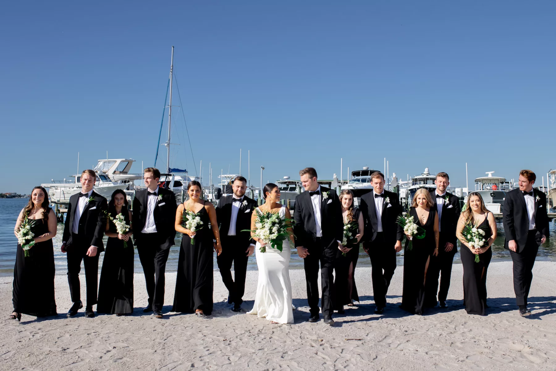 Bridal Party Wearing Black Suits and Mismatched Dresses Wedding Attire Inspiration | Tampa Bay Event Venue Isla Del Sol Yacht and Country Club
