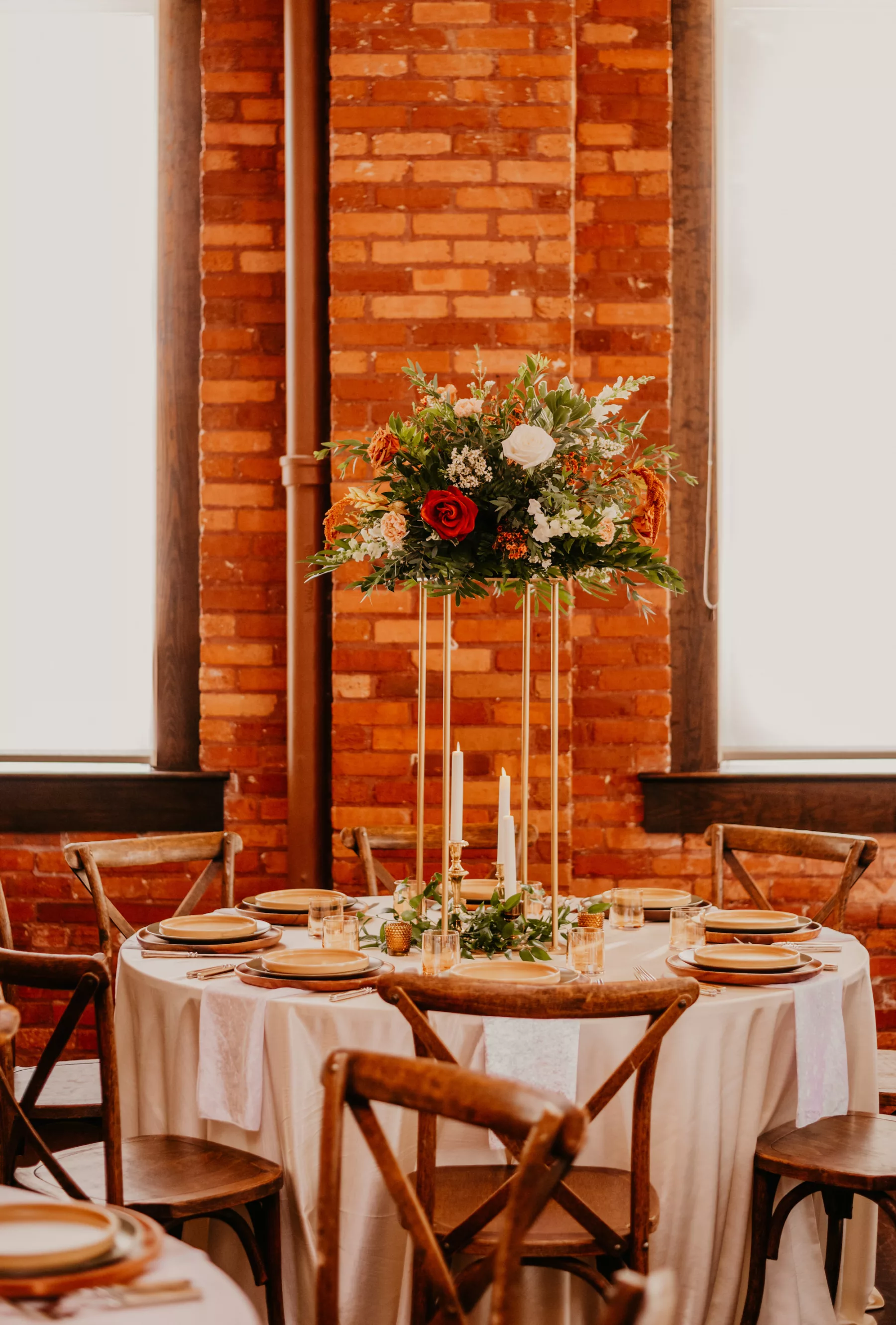 Boho Industrial Wedding Reception Decor Inspiration | Gold Flower Stands with White Roses, Terracotta Amaranthus, and Greenery | Wooden Crossback Chairs | Kate Ryan Event Rentals |