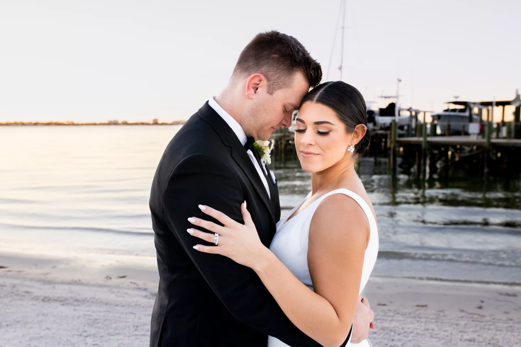 Romantic Bride and Groom Sunset Wedding Portrait | Elegant Updo Hair and Makeup Ideas | St Pete Hair and Makeup Artist Femme Akoi Beauty Studio | Venue Isla Del Sol Yacht & Country Club