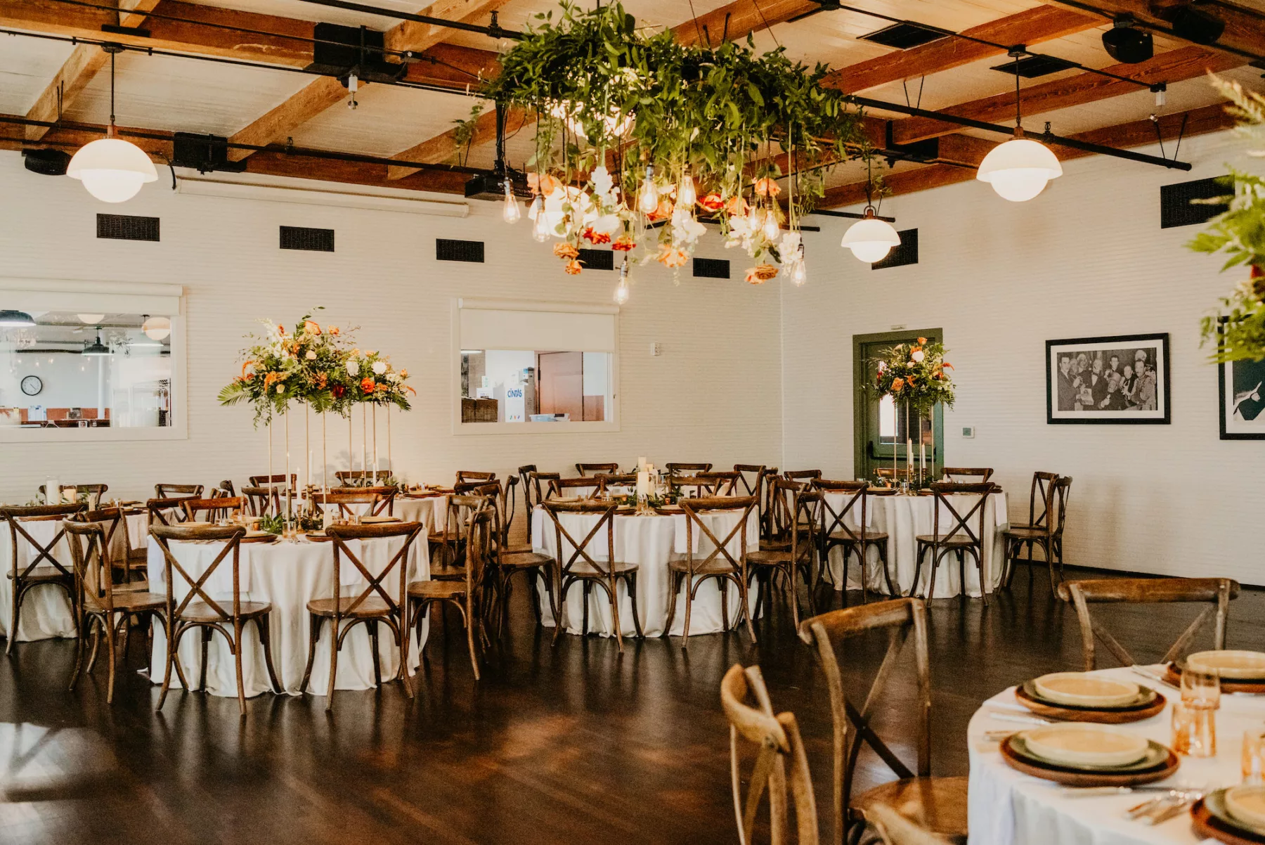 Boho Industrial Wedding Reception Decor Inspiration | Gold Flower Stands with White Roses, Terracotta Amaranthus, and Greenery | Orange and White Rose Flower Chandelier Inspiration | Wooden Crossback Chairs | Tampa Bay Furniture Kate Ryan Event Rentals | Ybor Planner B Eventful | Historic Industrial Venue J.C. Newman Cigar Co.