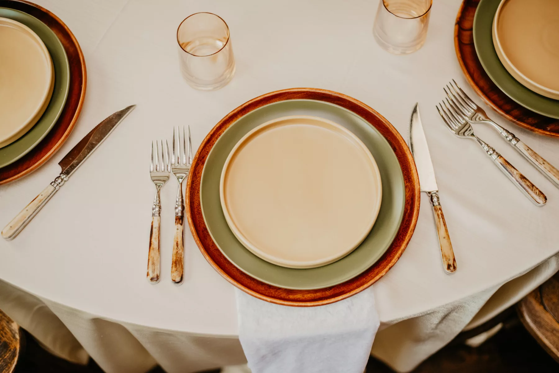 Boho Neutral Wedding Reception Tablesetting with Terracotta Charger, Green Dinner Plate, and Beige Salad Plate with Vintage Gold Flatware Ideas