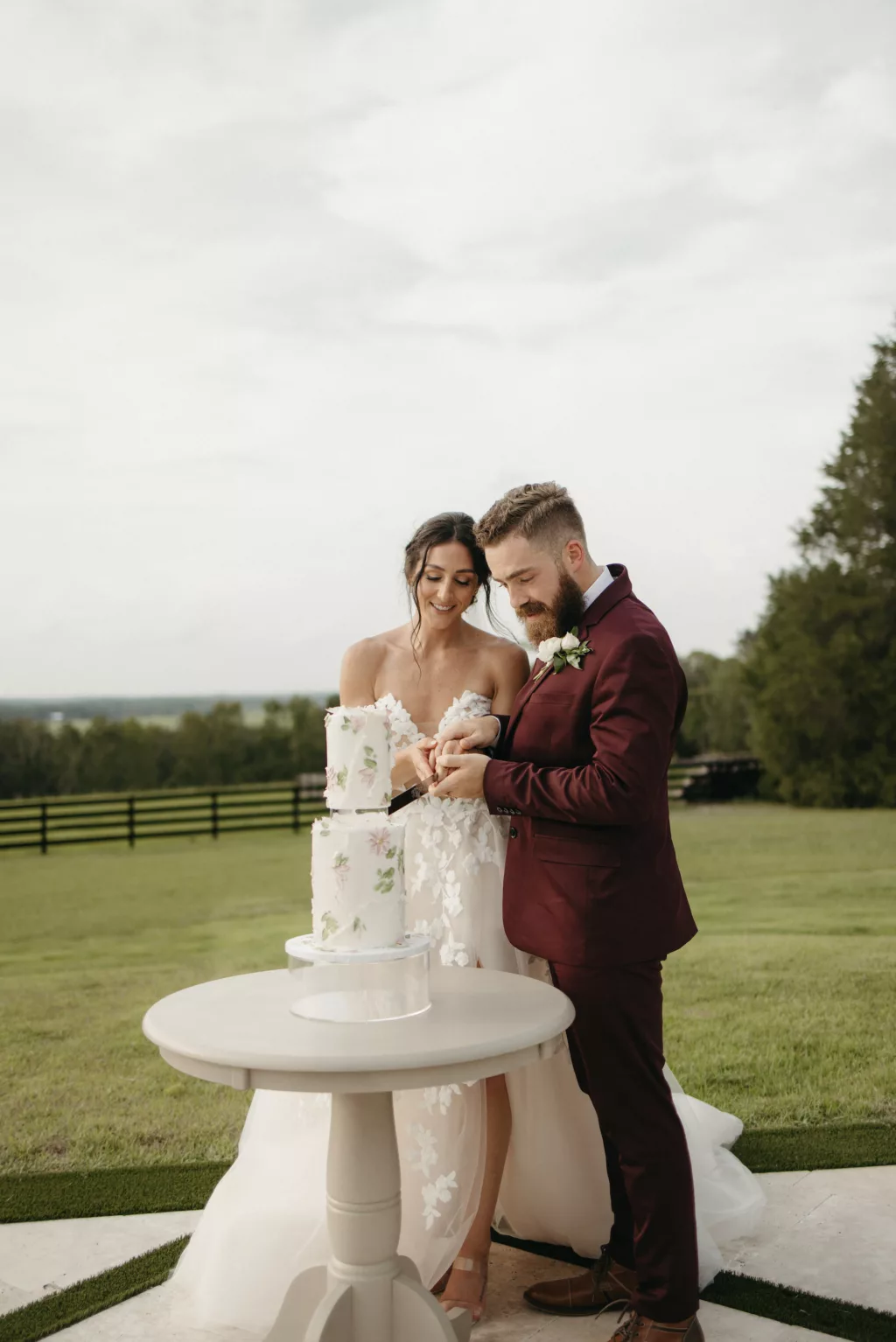 Bride and Groom Cutting the Cake Wedding Portrait | Round Two-Tiered Cake with Floating Tier and Floral Detail Inspiration | Tampa Event Planner The Olive Tree Weddings