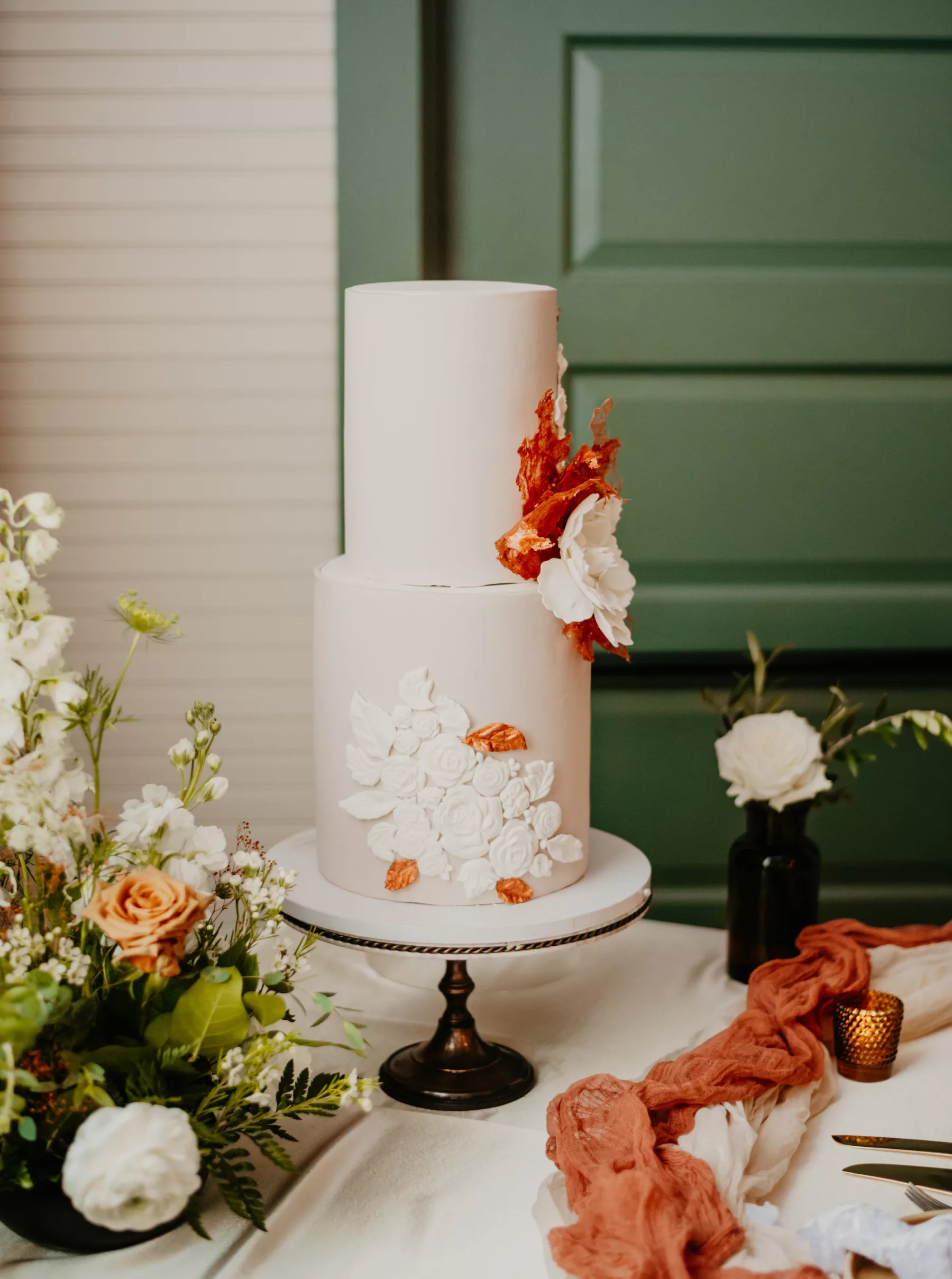 Boho Two-Tiered Round Cake with Fondant White Flowers and Terracotta Rice Paper | Tampa Bay Bakery The Artistic Whisk