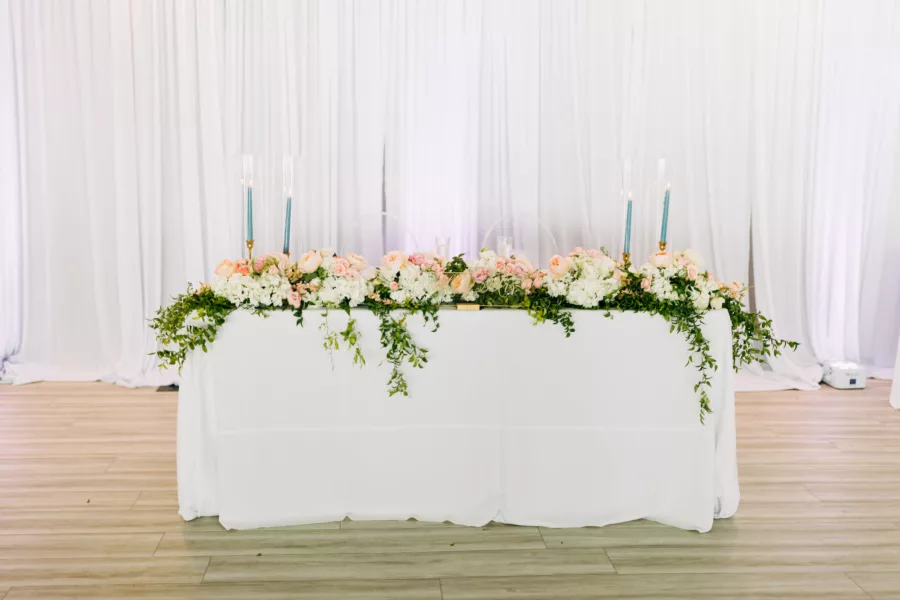 Romantic Dusty Blue Wedding Reception Sweetheart Table Decor Ideas | Blue Taper Candles, Pink Garden Roses, Baby Spray Roses, White Hydrangeas, and Greenery Centerpiece Inspiration | Tampa Bay Florist Beneva Flowers