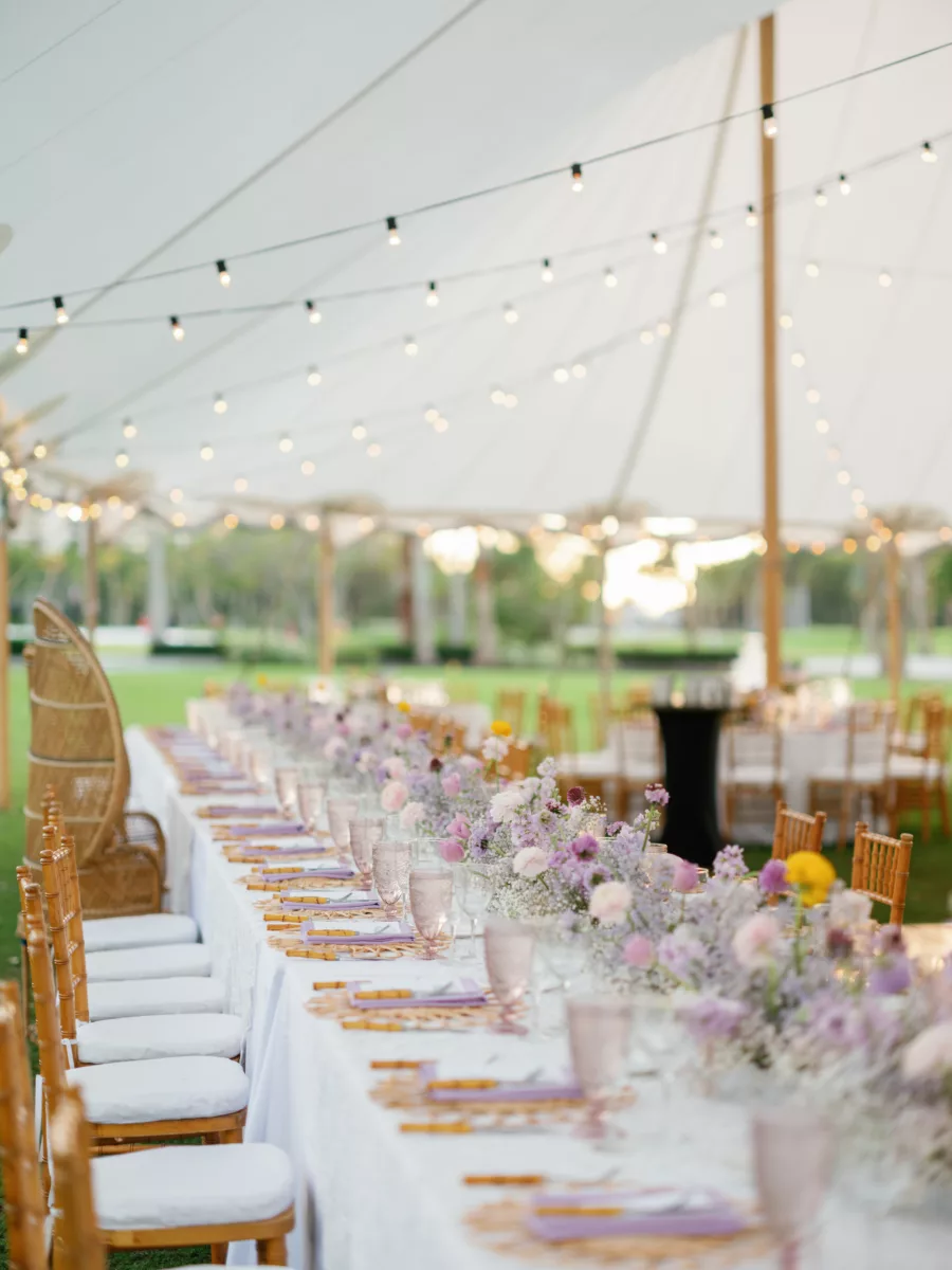 Long Feasting Table with Rattan Flower Placemat, Purple Napkins, Bamboo Flatware | Purple Hydrangrea, Baby's Breath, and Pink Ranunculus Centerpiece Ideas | Luxurious Pastel Wedding Reception Inspiration | Tampa Bay Event Venue The Resort at Longboat Key Club
