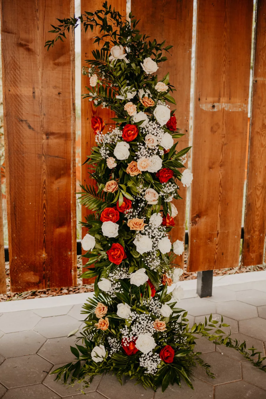 Outdoor Industrial Wedding Ceremony Inspiration | Terracotta, Orange, and White Roses, Baby's Breath, and Greenery Backdrop Ideas