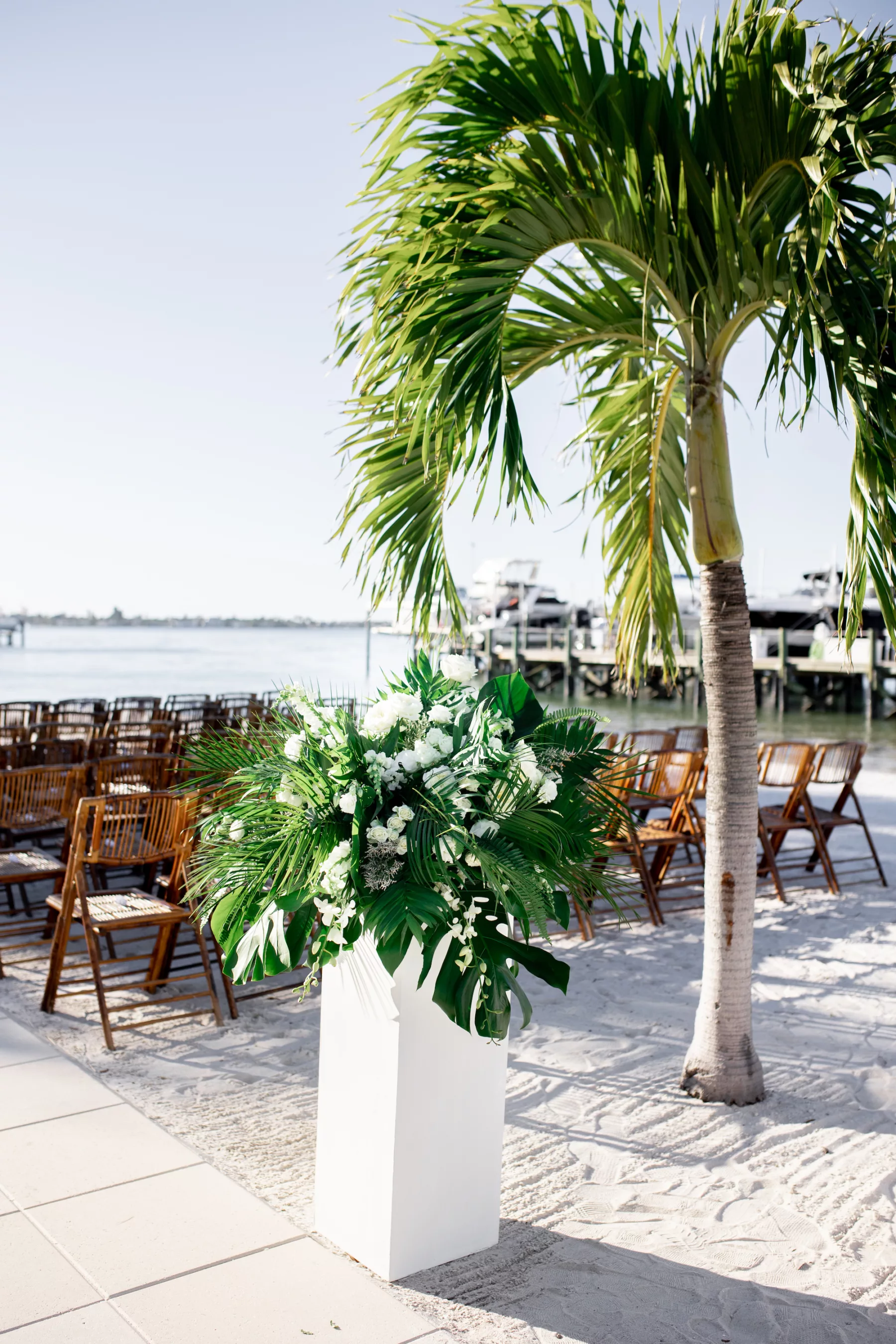 Modern White Square Pillar with Monstera, Palm Leaf, and White Roses | Tropical Beach Winter Wedding Ceremony Decor Inspiration