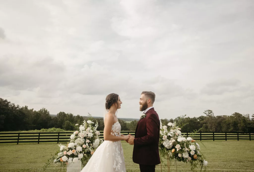 Romantic Outdoor Wedding Ceremony Vow Exchange Inspiration | Groom's Maroon Suit Ideas | Tampa Bay Event Venue La Hacienda at Snow Hill