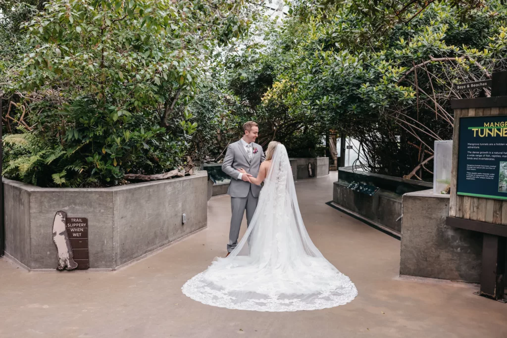 Bride and Groom at the Mangrove Tunnel Tropical Wedding Portrait | Tampa Bay Event Venue The Florida Aquarium | Bride and Groom Balcony Wedding Portrait | Photographer Lifelong Photography | Dress Truly Forever Bridal