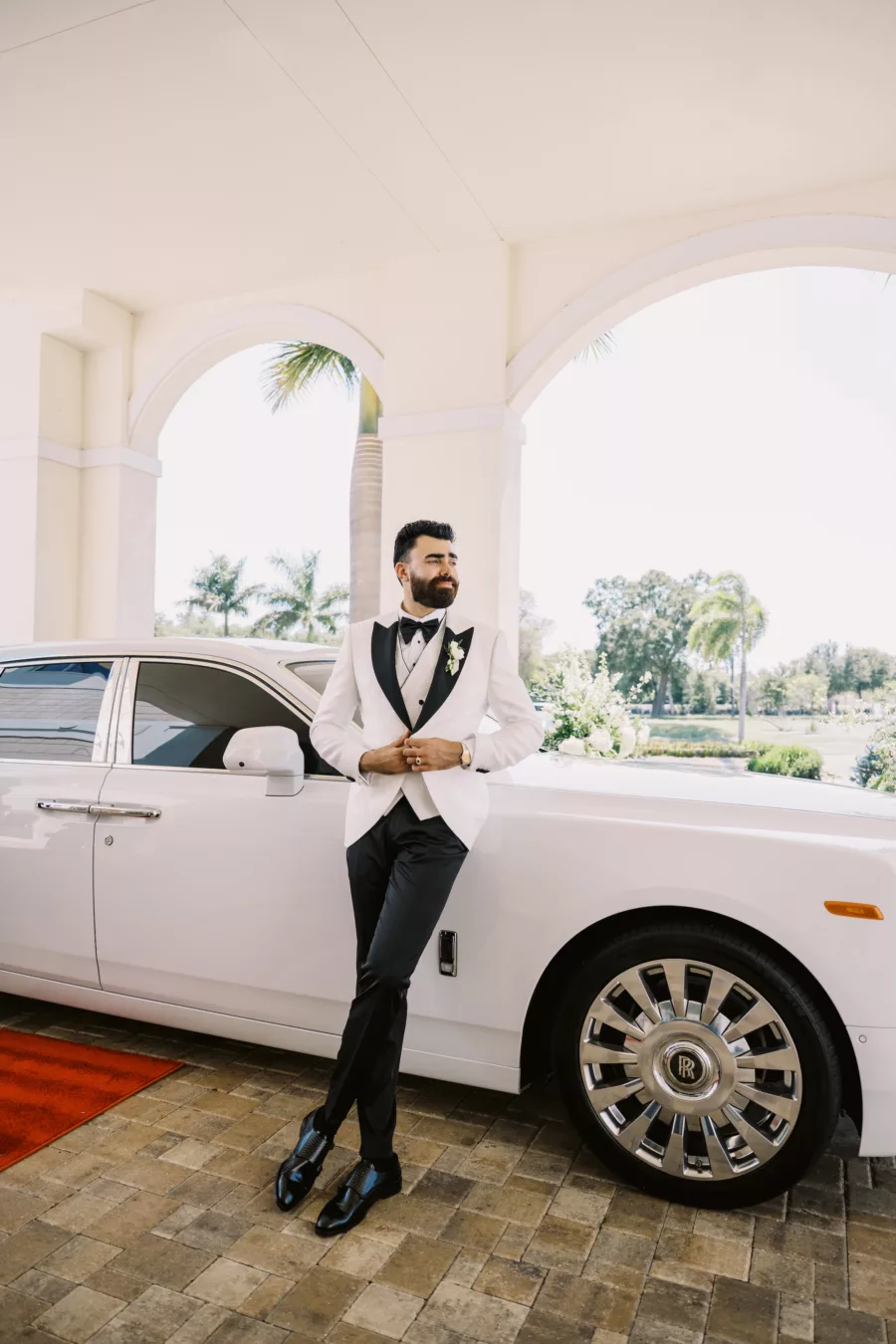 Groom's Wedding Day Attired Ideas | Black and White Three Piece Tuxedo | White Rolls Royce Getaway Car Inspiration