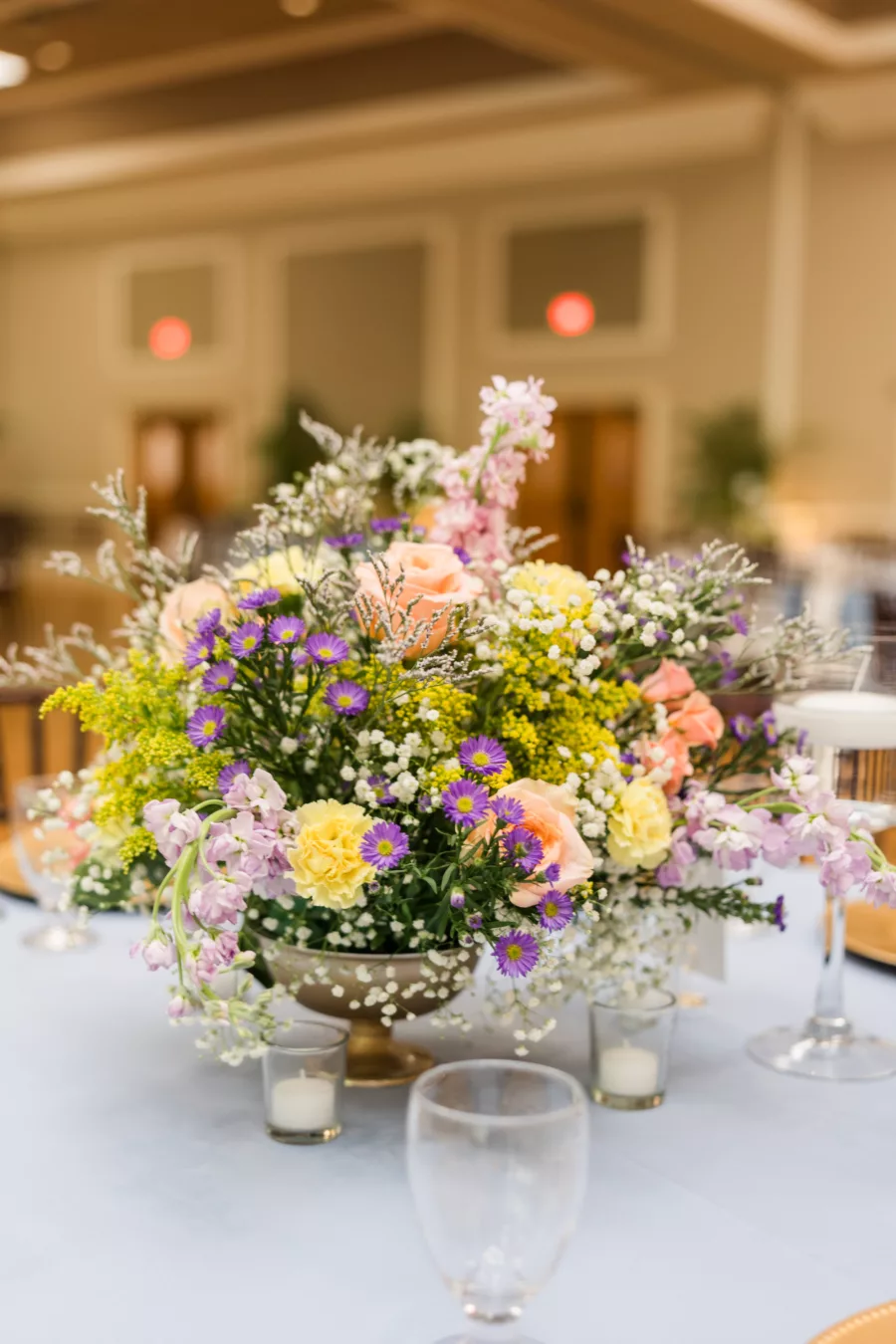 Whimsical Spring Garden Inspired Centerpiece Decor Ideas | Purple Daisies, Baby's Breath, Yellow Carnations, Peach Roses Floral Arrangement Inspiration