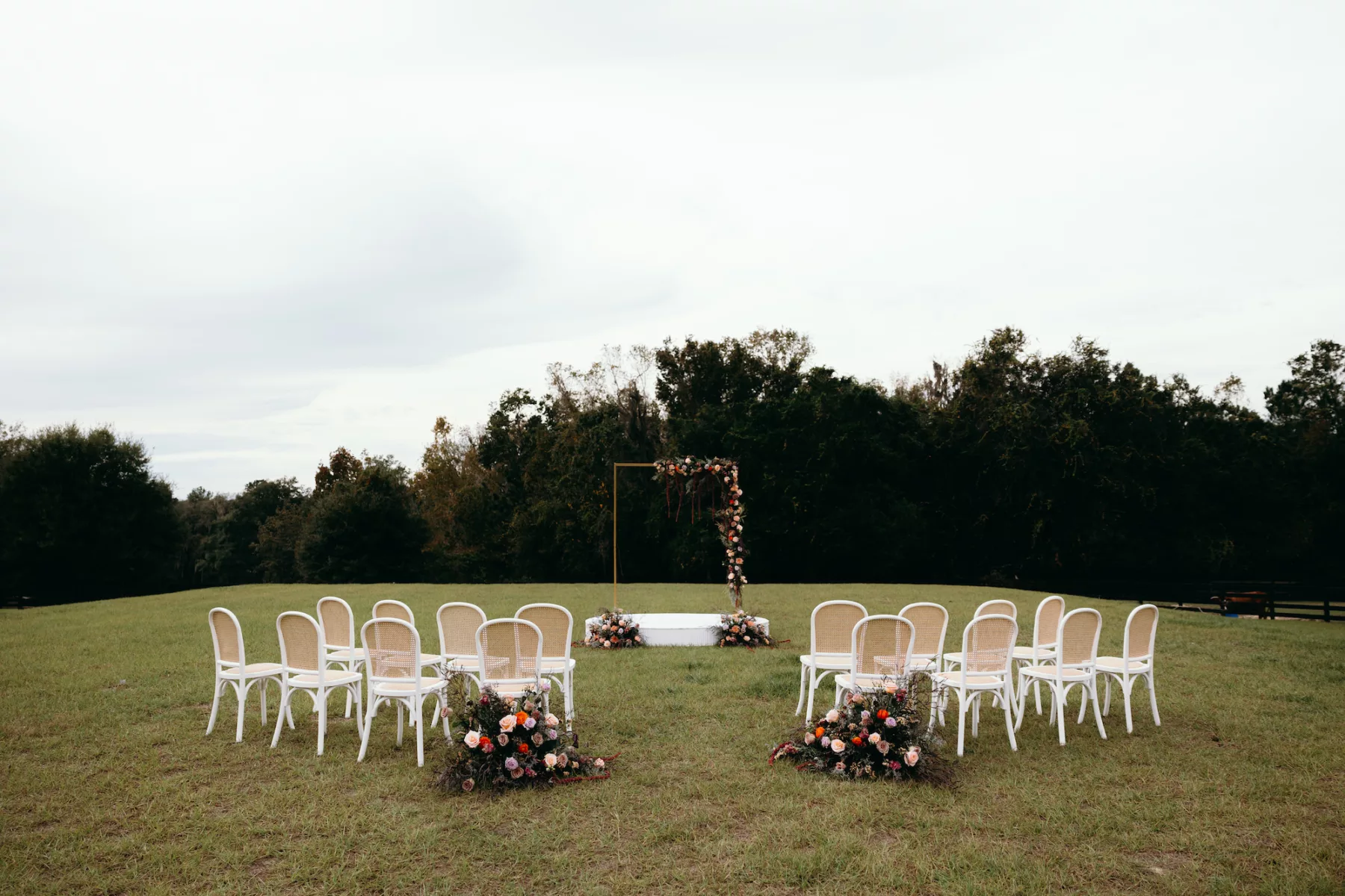 Moody Purple and Peach Whimsical Outdoor Field Fall Wedding Ceremony Inspiration | White and Rattan Chair Ideas | Pink, Orange, Purple, and White Roses, Amaranthus, and Greenery Aisle Decor | Tampa Bay Event Venue La Hacienda At Snow Hill | Planner MDP Events | Florist Save The Date Florida