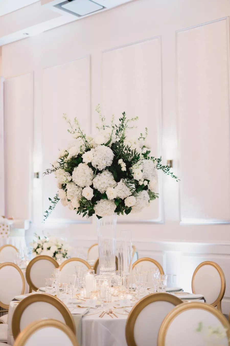 Elegant Spring White and Gold Ballroom Wedding Centerpiece Decor Ideas | White Hydrangeas, Roses, and Greenery with Tall Glass Vase | Tampa Bay Florist Bruce Wayne Florals