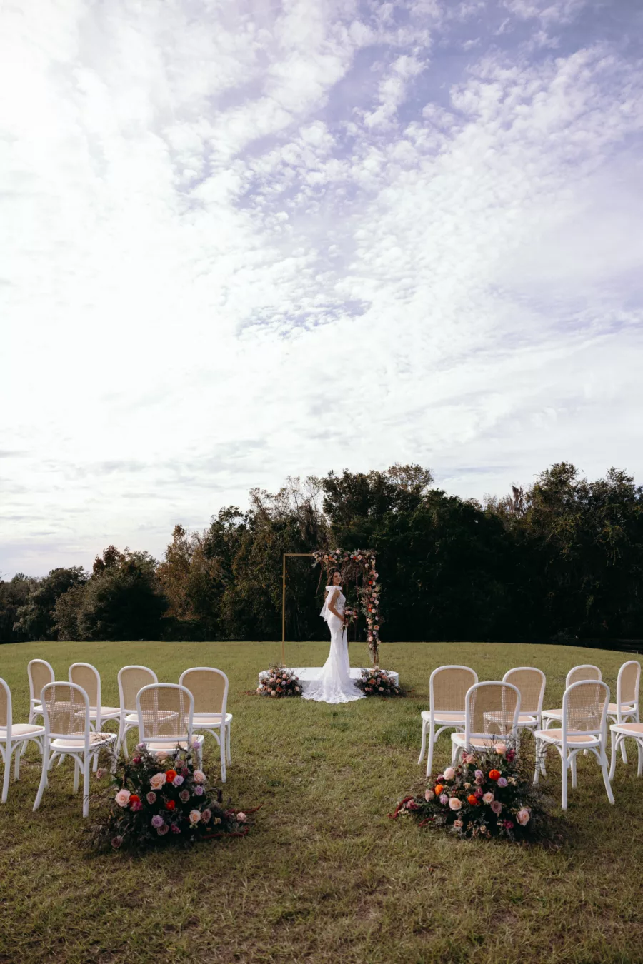 Moody Purple and Peach Wedding Ceremony with White Stage | Whimsical Purple and Peach Roses, Chrysanthemums, Amaranthus, and Greenery Wedding Ceremony Gold Arbor Decor Inspiration | Tampa Bay Event Venue La Hacienda At Snow Hill | Planner MDP Events | Florist Save The Date Florida | Photographer Arianna J Photography