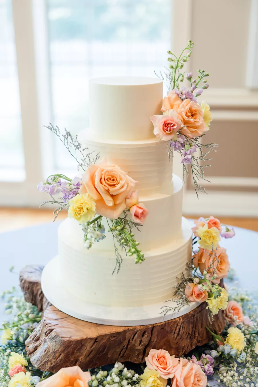 Round Four-Tiered Textured White Wedding Cake with Peach Roses, Yellow Carnations Flower Accent Ideas