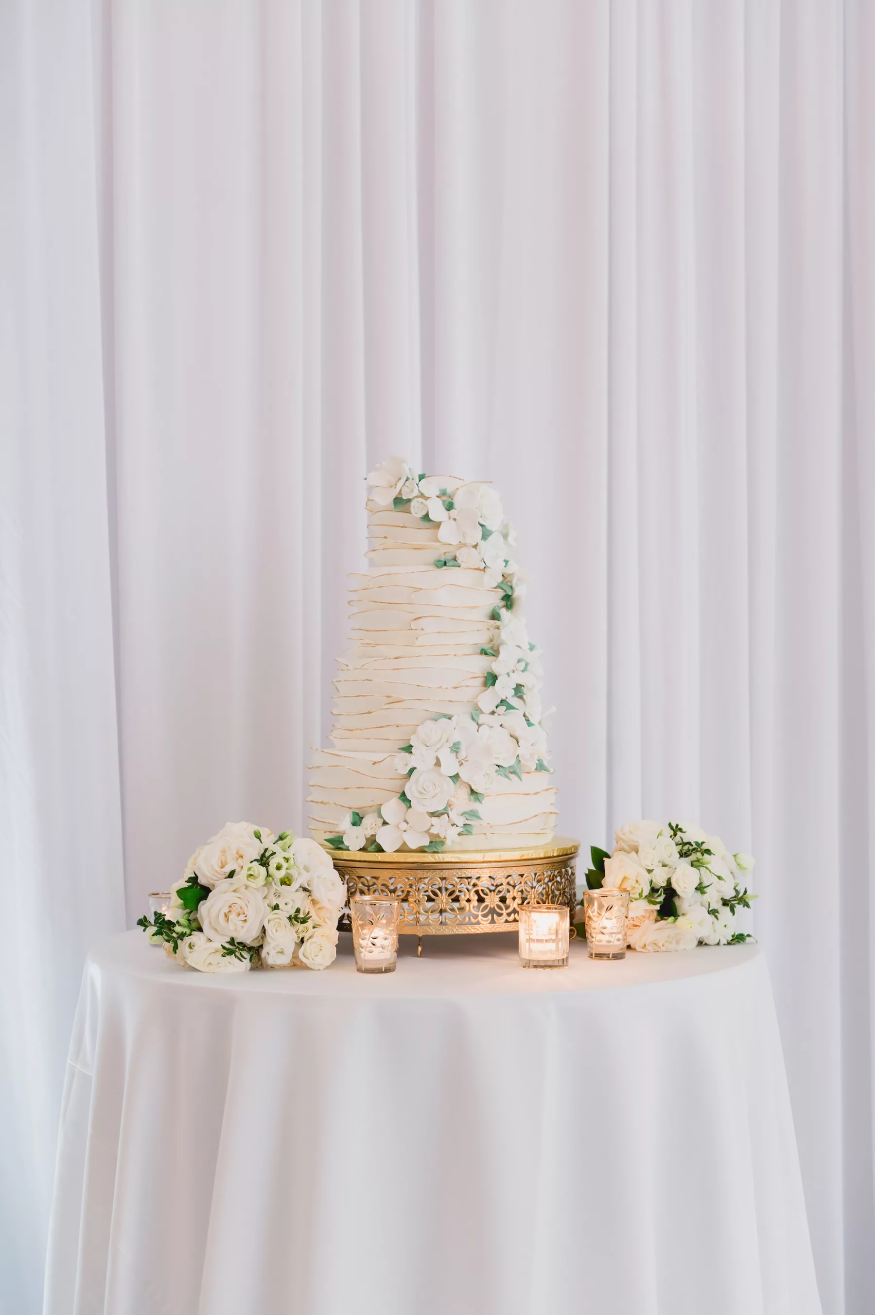 Round Four-Tiered Textured White and Gold Wedding Cake with Edible Flowers Inspiration | Classic Cake Table Decor Inspiration