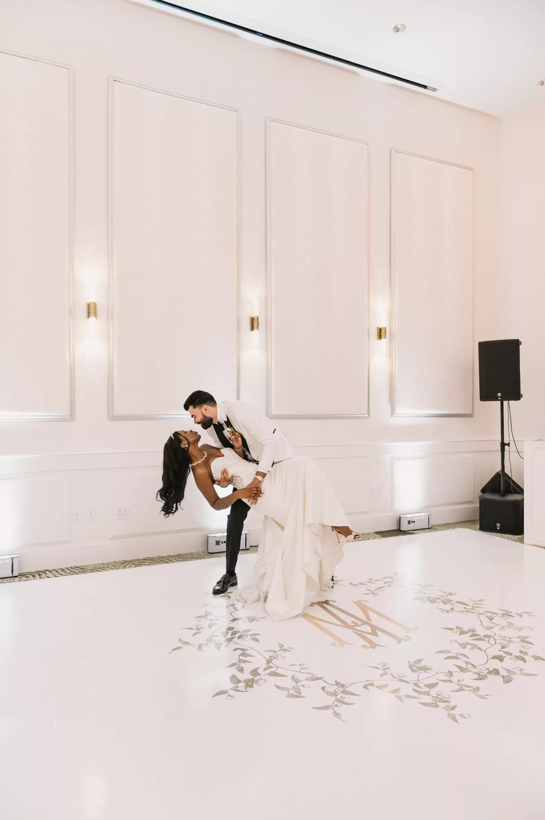 Bride and Groom First Dance Ballroom Wedding Portrait | White Dance Floor with Custom Gold Monogram Ideas | Clearwater Planner Parties A La Carte