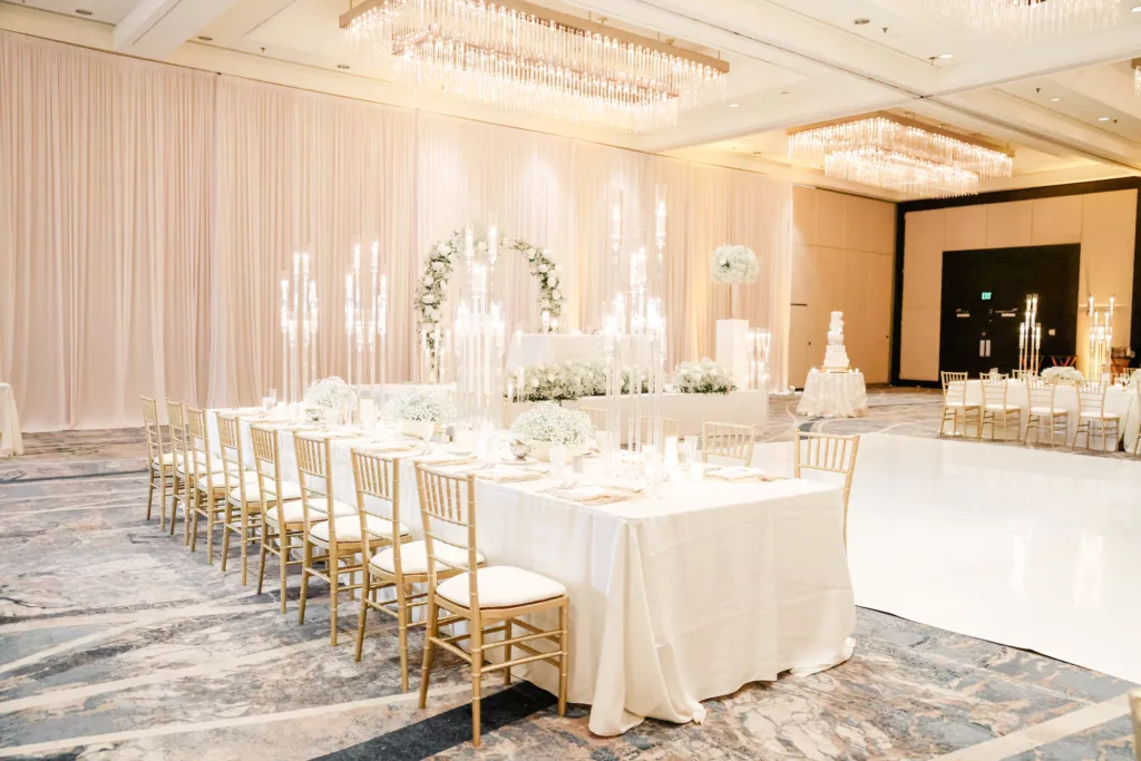 Extravagant Ivory, White, and Gold Wedding Reception Feasting Table Tablescape Decor Inspiration | Tall Modern Acrylic Candelabra Centerpiece Ideas | Gold Chiavari Chairs | Tampa Bay Hotel Venue Hilton Tampa Downtown