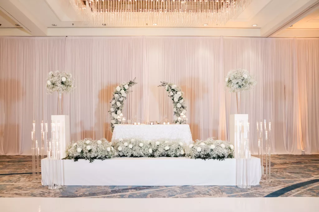Extravagant White Modern Sweetheart Table with White Baby's Breath, Chrysanthemums, and Greenery Backdrop and Floor Arrangement Wedding Reception Decor Ideas | Tampa Bay Event Venue Hilton Tampa Downtown | Planner Special Moments Event Planning | Photographer Lifelong Photography Studio