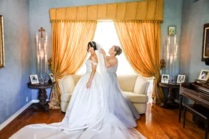 Bride and Mother Getting Ready | Ivory Off The Shoulder Beaded Bodice A-Line Ballgown Stephen Yearick Couture Wedding Dress Inspiration | Bridal Tiara Updo Hair and Makeup Ideas | Tampa Bay Hair and Makeup Artist Femme Akoi Beauty Studio | Photographer Lifelong Photography Studio