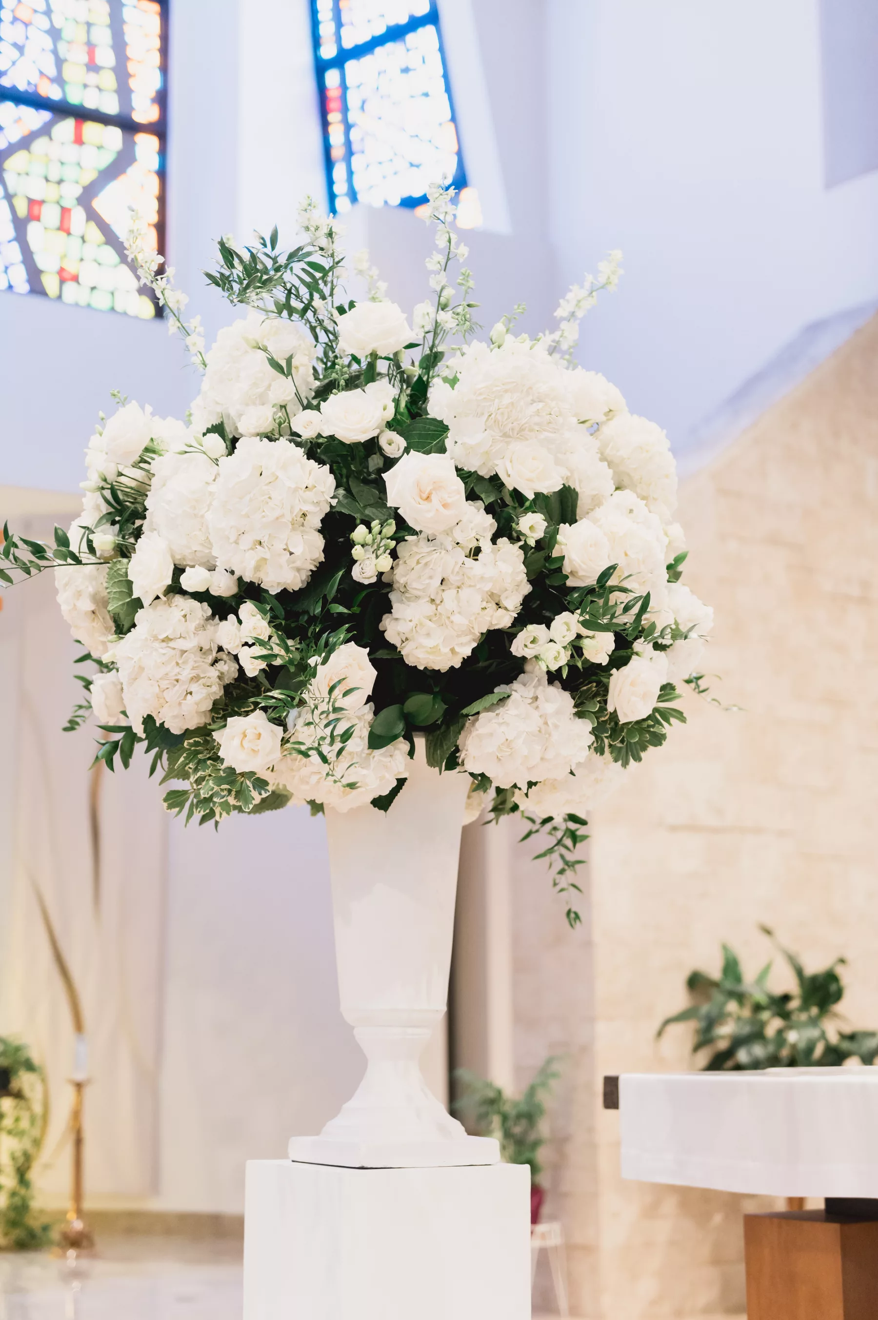 Elegant Spring White Catholic Wedding Ceremony Decor Ideas | White Hydrangeas, Roses, and Greenery with Tall Glass Vase | Tampa Bay Florist Bruce Wayne Florals