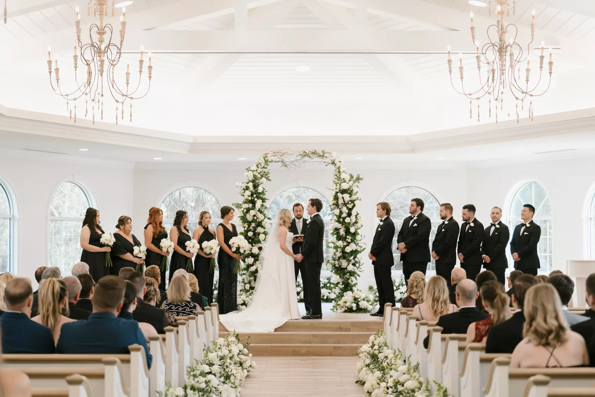 Bride and Groom Just Married Wedding Portrait | Classic Wedding Ceremony Aisle Decor Ideas | White Roses, Baby's Breath, Hydrangeas, and Greenery Flower Arrangements | Safety Harbor Venue Harborside Chapel