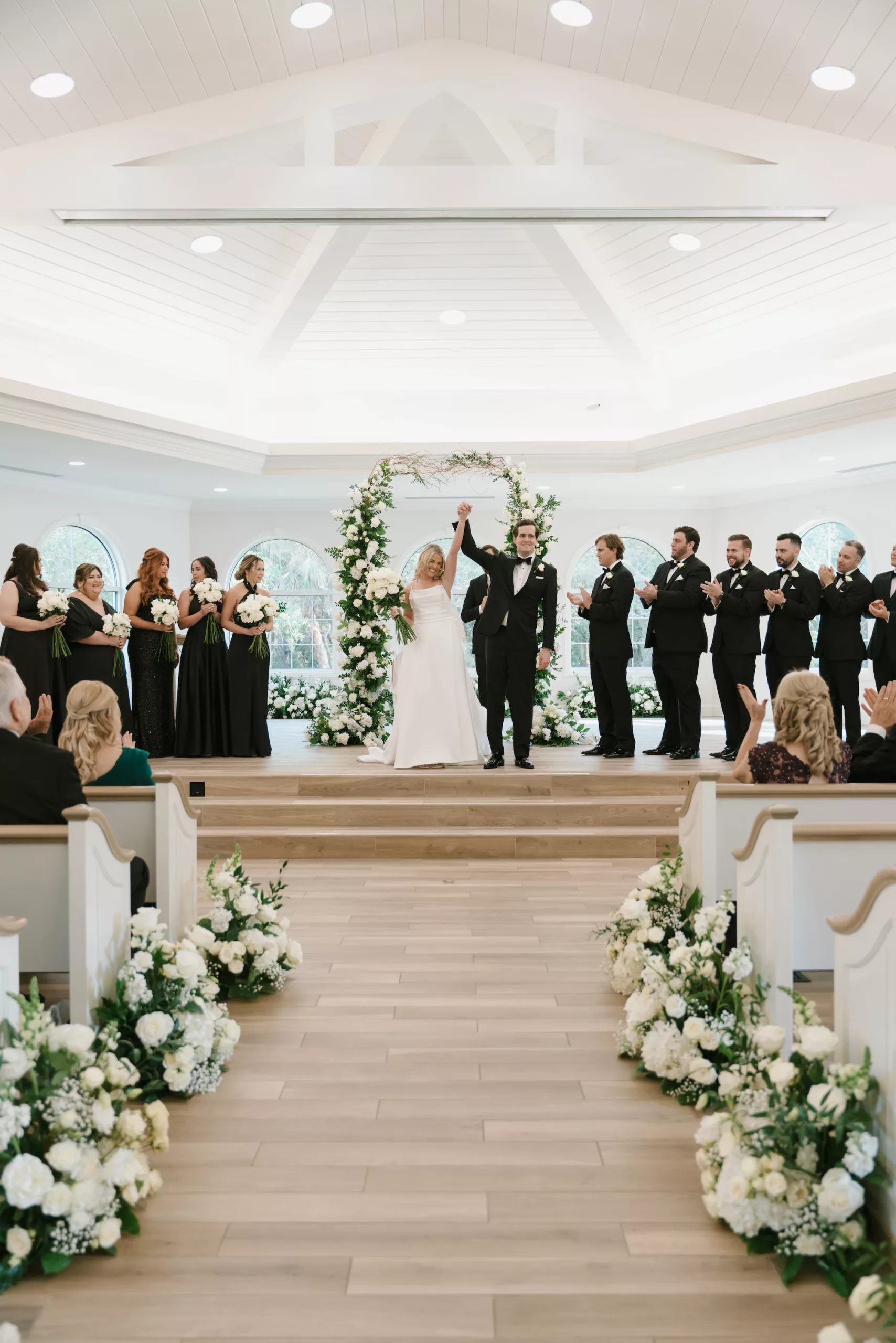 Bride and Groom Just Married Wedding Portrait | Classic Wedding Ceremony Aisle Decor Ideas | White Roses, Baby's Breath, Hydrangeas, and Greenery Flower Arrangements | Tampa Bay Event Venue Harborside Chapel