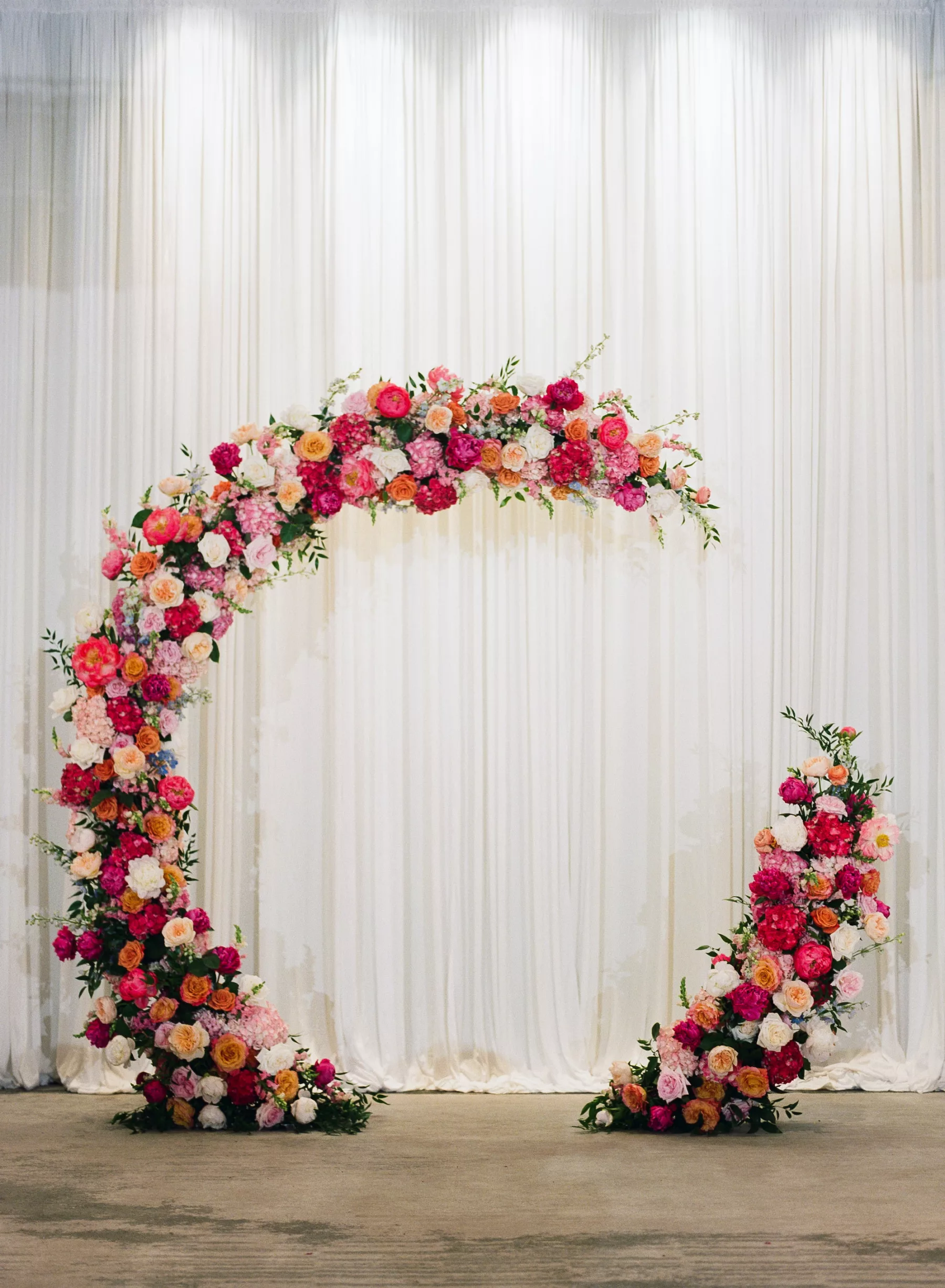 Round Wedding Ceremony Arch Inspiration with Pink Hydrangeas and Orange Garden Roses | White Drapery | St Pete Florist Bruce Wayne Florals | Kate Ryan Event Rentals