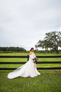 White Tulle A-Line Wedding Dress with Off The Shoulder Puff Sleeves | Tampa Bay Event Venue Legacy Lane Weddings | Photographer Limelight Photography | Videographer Priceless Studio