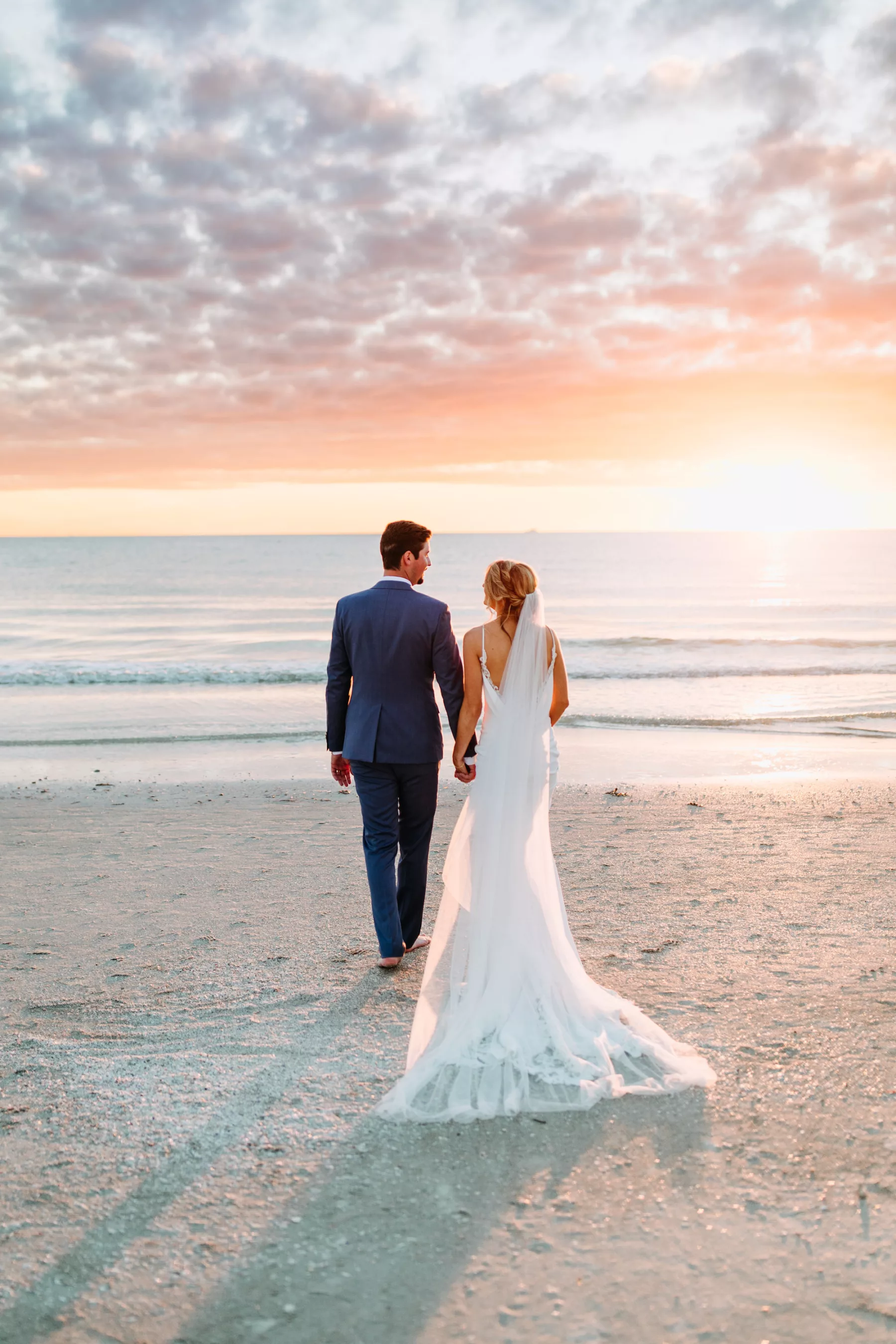 Bride and Groom Walking on the Beach Wedding Portrait | Madeira Beach Photographer Amber McWhorter Photography | Videographer Priceless Studio Design