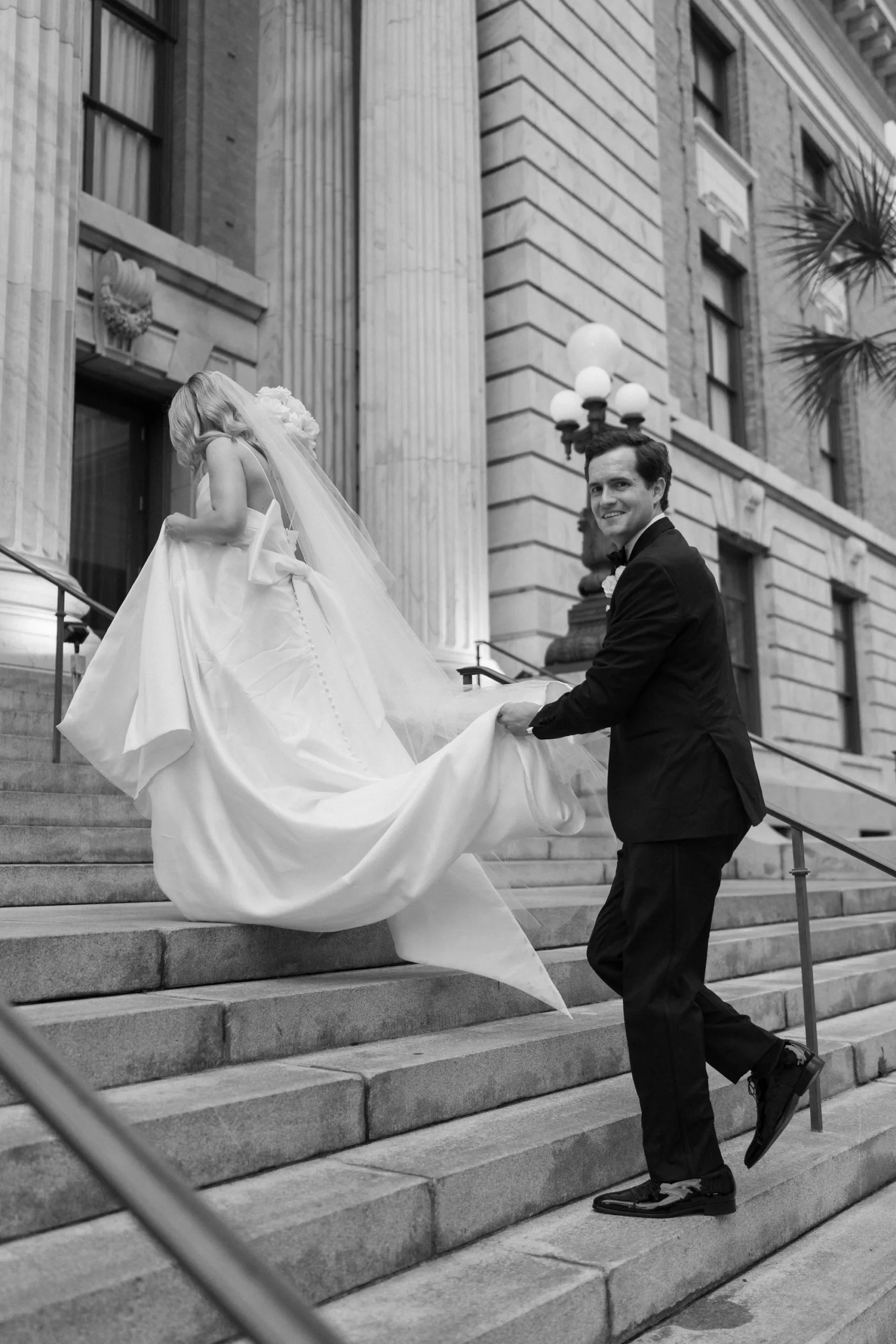 Romantic White Satin A Line Wedding Dress with Bow Inspiration | Groom's Black Tie Tuxedo Attire Ideas | Downtown Tampa Venue Le Meridien