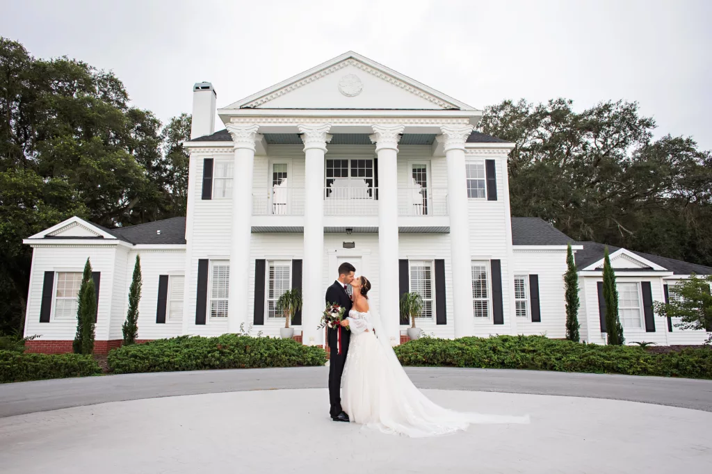 Bride and Groom In Front of Southern Estate | Tampa Bay Private Estate Venue Legacy Lane Weddings | Photographer Limelight Photography | Videographer Priceless Studio Design