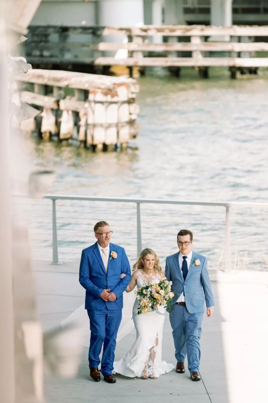 Bride with Father and Brother Walking Down Wedding Aisle