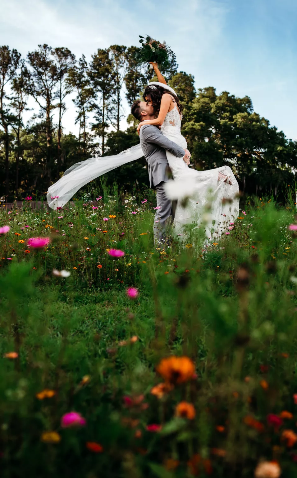 Bride and Groom Walking Through Wildflower Garden Sunset Wedding Portrait | Tampa Bay Photographer Sabrina Autumn Photography