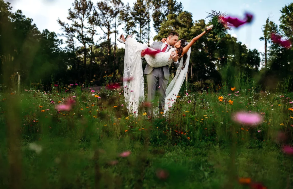 Bride and Groom Walking Through Wildflower Garden Sunset Wedding Portrait | Tampa Bay Photographer Sabrina Autumn Photography