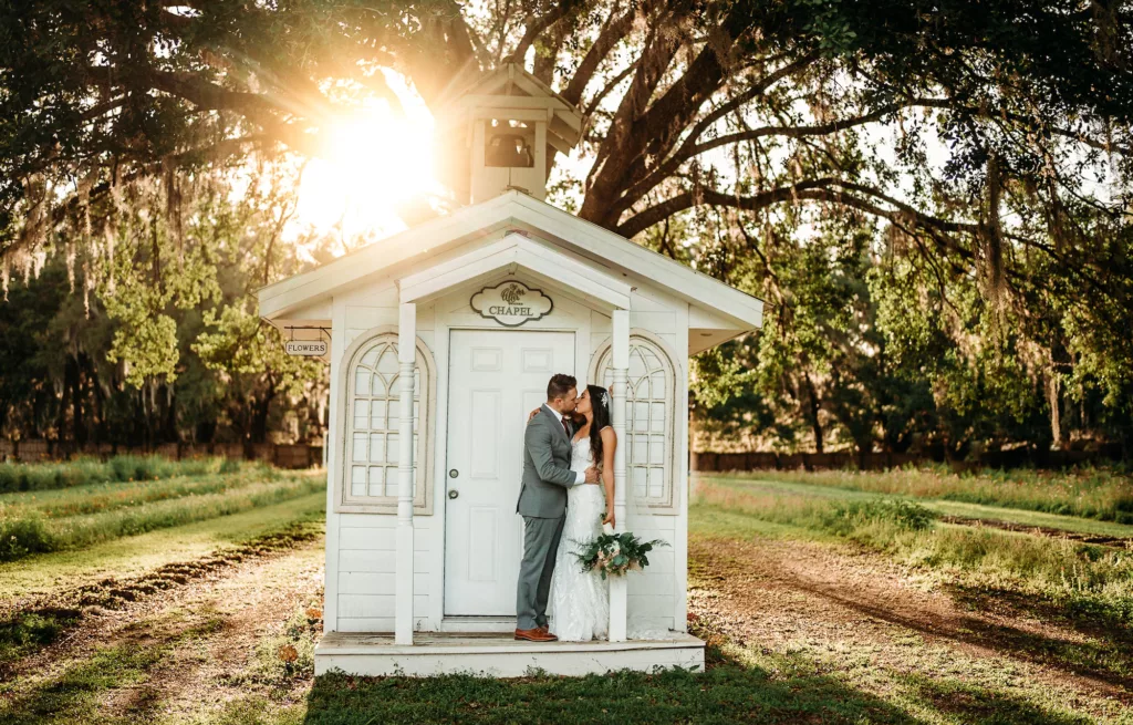 Bride and Groom Chapel Sunset Wedding Portrait | Tampa Bay Photographer Sabrina Autumn Photography | Florida Event Venue Ever After Farms Flower Wedding Barn