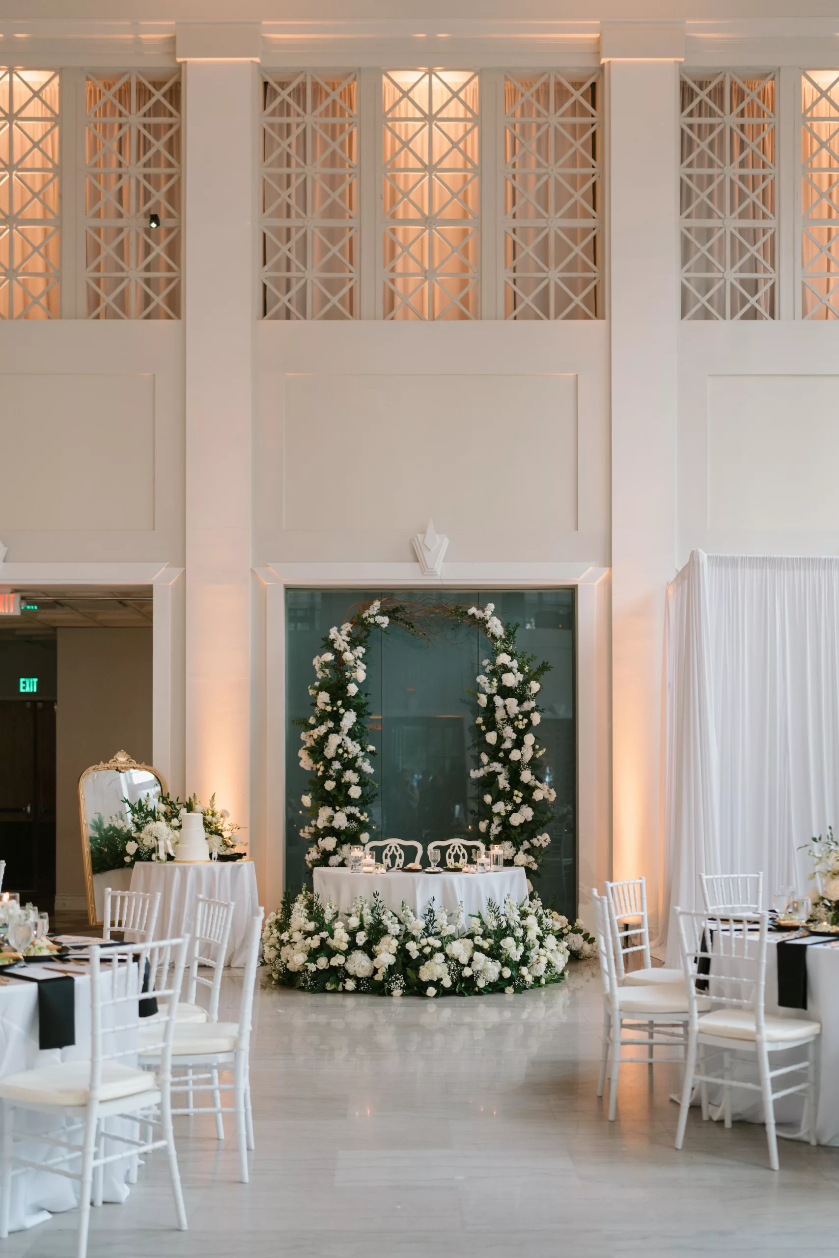 Classic Wedding Reception Sweetheart Table Inspiration | White Roses, Hydrangeas, Baby's Breath, and Greenery Floral Arrangement Backdrop Ideas | Tampa Bay Event Venue The Vault